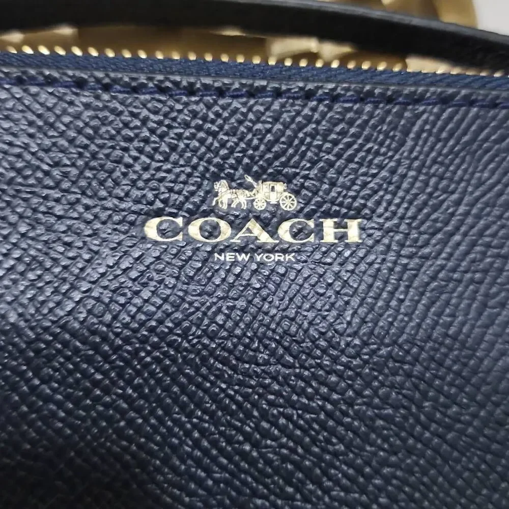 Coach Corner Zip Wristlet in crossgrain leather.